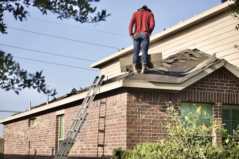 Professional roofer working on a residential roof in Philo